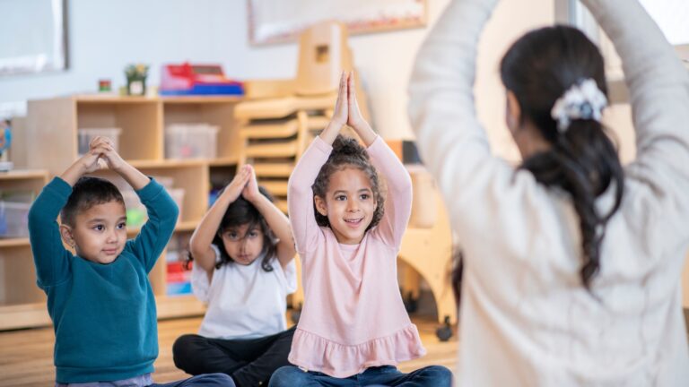 Teacher engages children to do an exercise before starting the class