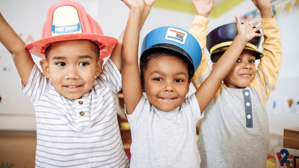 kids raising their hands happily