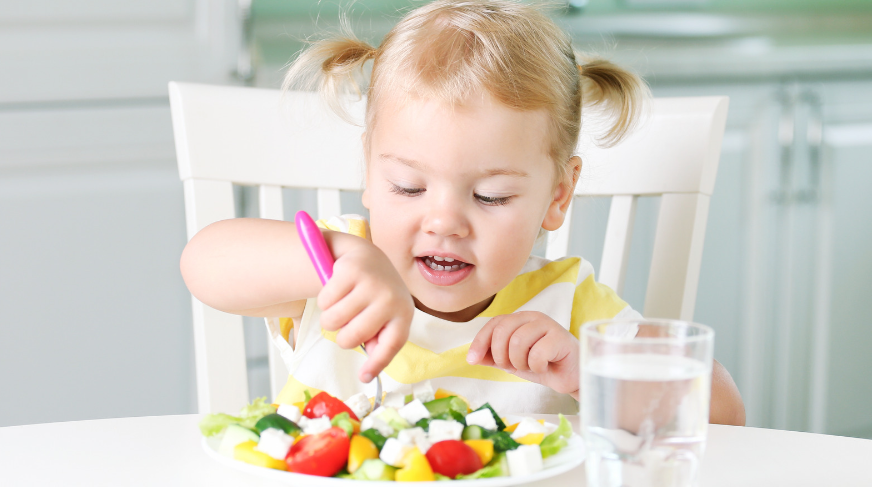 little girl eating nutritious foods